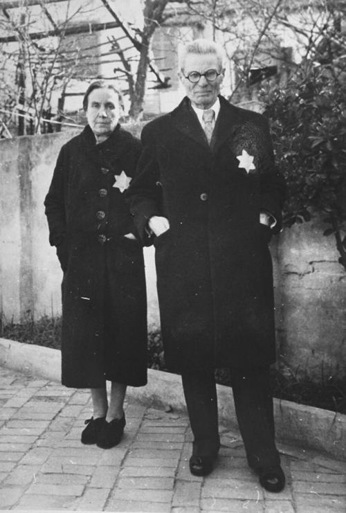 A Jewish couple wearing the yellow star poses on a street in Thessaloniki. Pictured are Rachel and Joseph Chasid, the parents of Margo (Chasid) Melech. United States Holocaust Memorial Museum Photo Archives